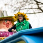 woman in green and yellow hat and black jacket