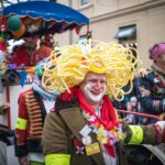 woman in yellow wig and green jacket